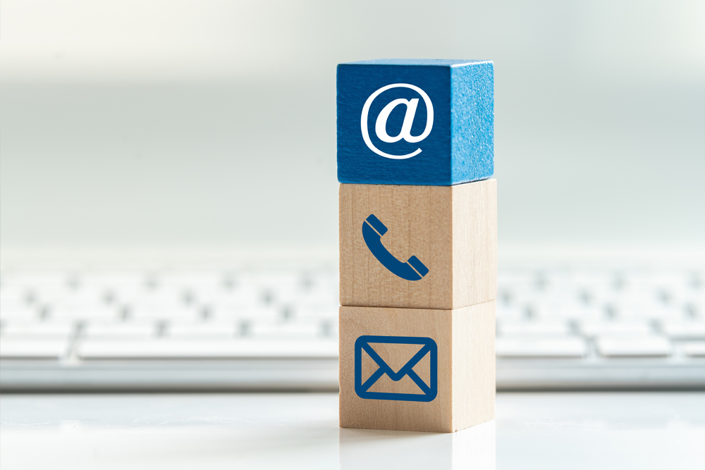 wooden blocks with @, phone and envelope icons